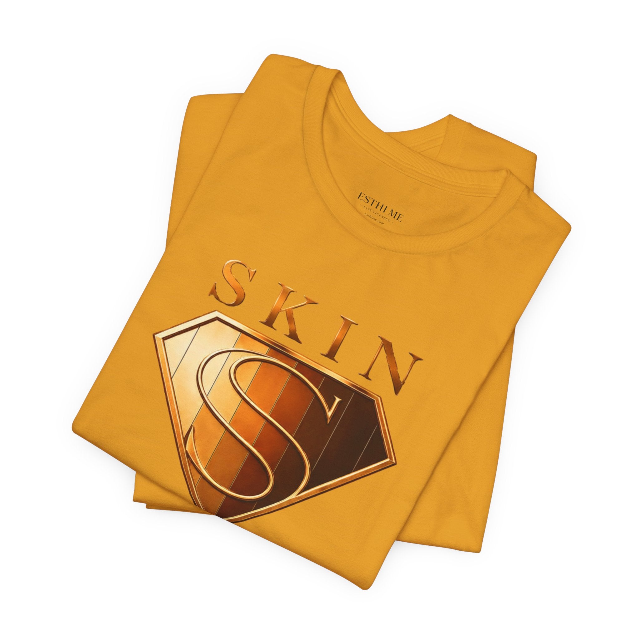 Folded golden Skin Girl™ graphic t-shirt featuring the signature shield design and barrier protection theme.