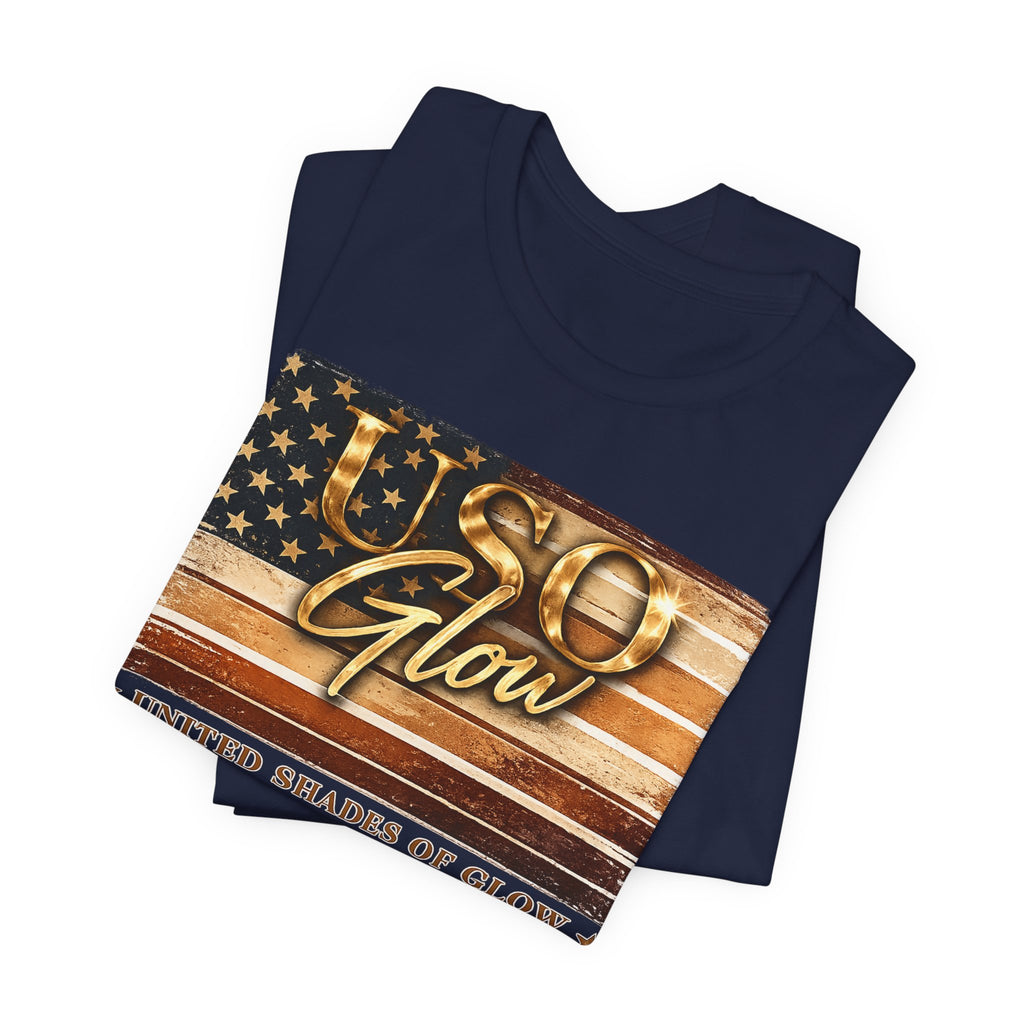 Folded navy blue United Shades of Glow™ t-shirt featuring a beauty and skincare-inspired patriotic graphic.