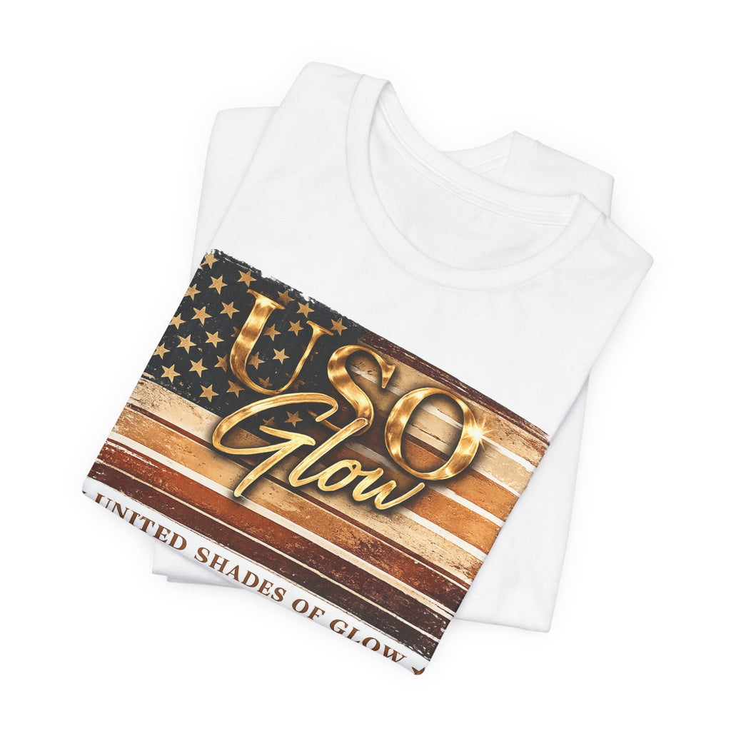 Folded white United Shades of Glow™ t-shirt featuring a patriotic beauty-inspired graphic celebrating skin confidence.