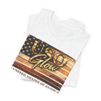 Folded white United Shades of Glow™ t-shirt featuring a patriotic beauty-inspired graphic celebrating skin confidence.
