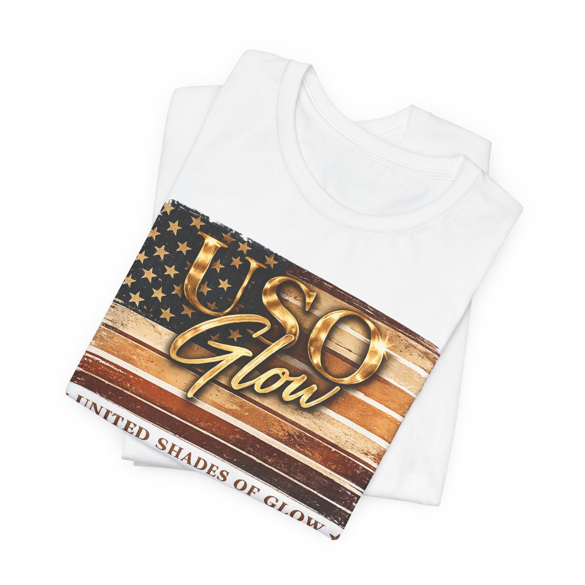 Folded white United Shades of Glow™ t-shirt featuring a patriotic beauty-inspired graphic celebrating skin confidence.