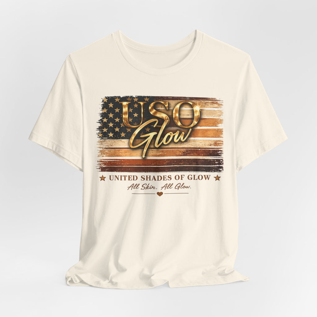 Cream unisex t-shirt featuring the United Shades of Glow™ graphic with an American flag design celebrating diversity, beauty, confidence, and every shade of skin.