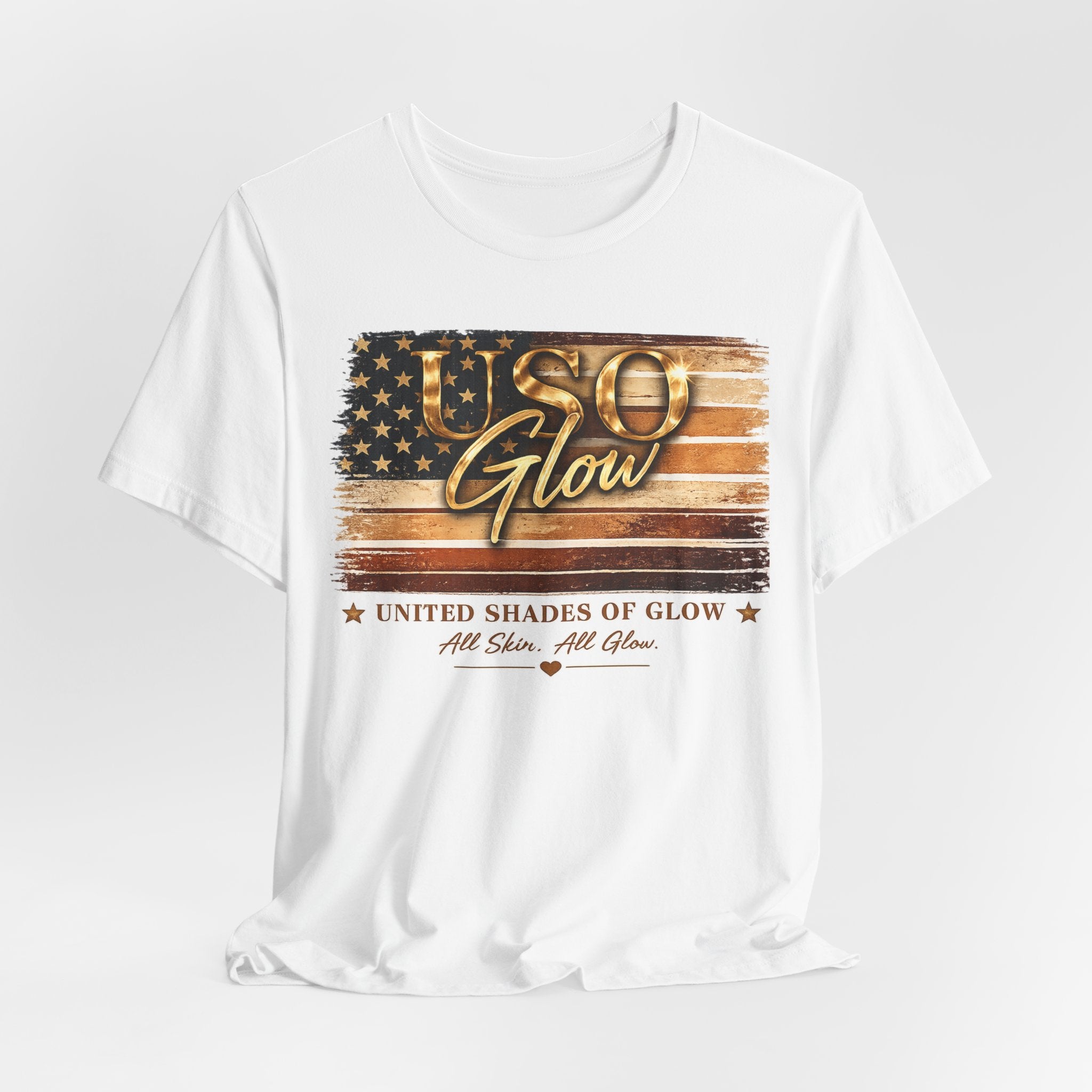 White unisex graphic t-shirt featuring the United Shades of Glow™ patriotic skincare-inspired design with gold and bronze tones.