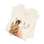 Folded natural color Skin Girl Fitz 3 golden esthetician graphic t-shirt displaying full front artwork